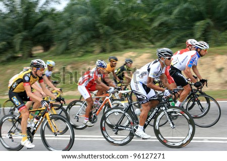 JASIN, MELAKA, MALAYSIA - FEBRUARY 26 : The largest group of cyclists from various teams cycle during Stage 3 of the Tour de Langkawi from Melaka to Parit Sulong on February 26, 2012 in Melaka, Malaysia.