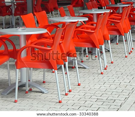 red plastic chairs in free air cafe