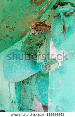 Green and rusty boat propeller