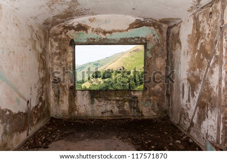 Old room and a landscape view through the window in Peaks of Europe  (Picos de Europa). Vega de Pas, Cantabria (Spain)