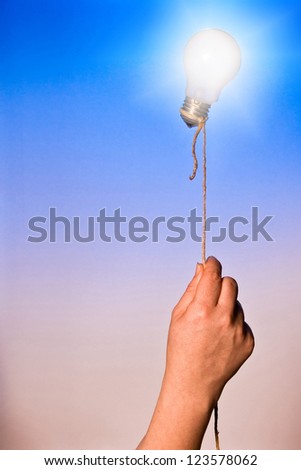 A light bulb floating attached by a rope