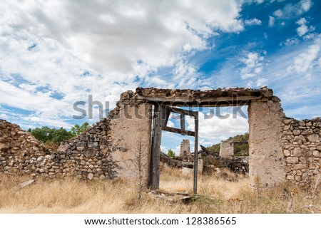 Ancient door in a stone wall, entrance to an old house