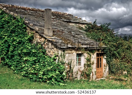 An old and rustic house surrounded with vegetation