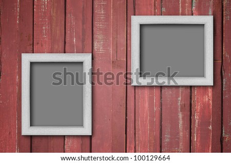 Two white wood picture frame on Red color paint plank wall for background