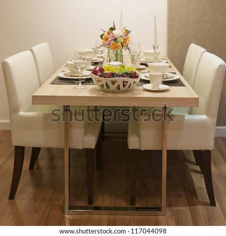 Side view of Top wood Dining Table and White leather chair