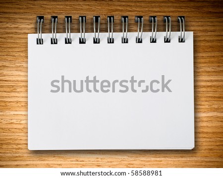 fix notebook on Oak wood board background