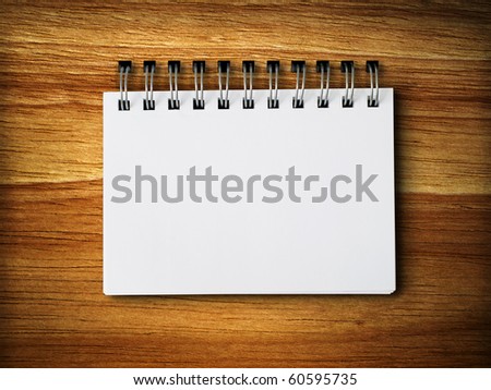 white blank note paper on rubber wood background