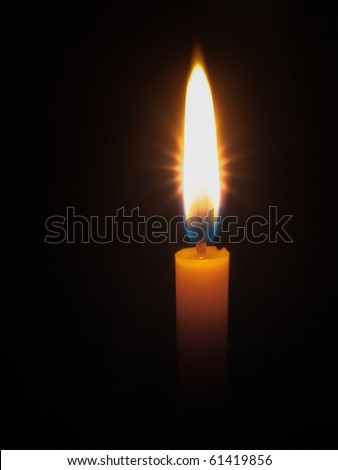 One Yellow candle  bright light in dark night