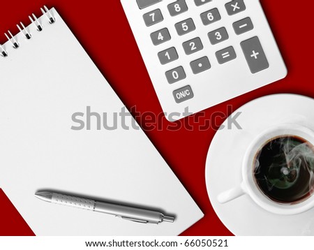 White calculator and white note paper with pen and white cup of hot coffee on red table