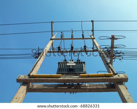 Transformer, power lines and electricity poles with a bright blue day