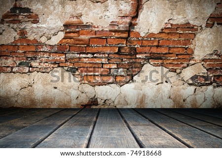 Cracked plaster of old brick wall and wood floor