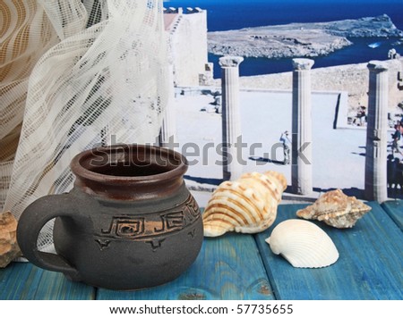 Memories of the island of Rhodes, still life with cup and photos Acropolis in Lindos on background