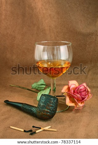 Romantic still life with old tobacco pipe and glass of whiskey