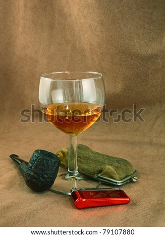 Romantic still life with old tobacco pipe and glass of whiskey
