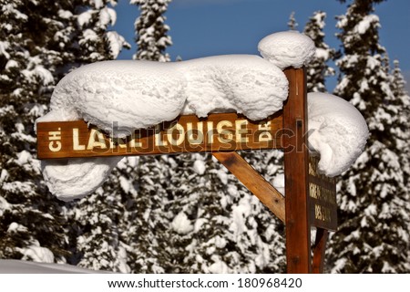 Snow packed on Lake Louise Drive sign