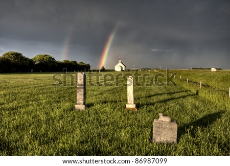 Old Country Church in Saskatchewan Canada with storm clouds rainbow