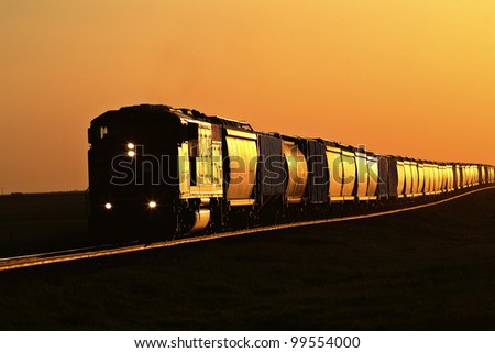 Setting sun reflecting off train and track