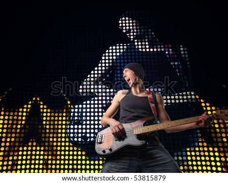 young guitar player at concert and led screen background