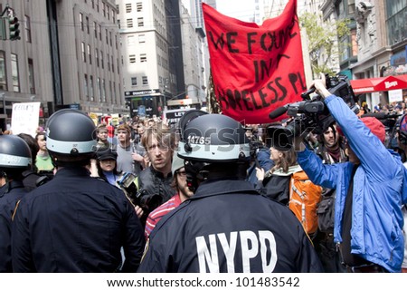 NEW YORK - MAY 1: Police attempt to guide angry protesters onto the sidewalk during the march to Union Square from Bryant Park during Occupy Wall St 'May Day' protests on May 1, 2012 in New York, NY.