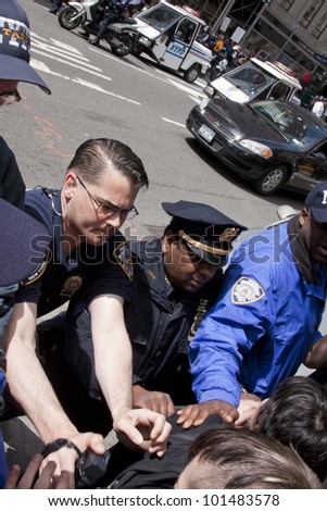 NEW YORK - MAY 1: Police attempt to guide angry protesters onto the sidewalk during the march to Union Square from Bryant Park during Occupy Wall St \'May Day\' protests on May 1, 2012 in New York, NY.