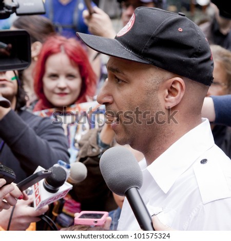 NEW YORK - MAY 1: Rage Against The Machine guitarist Tom Morello speaks to the media about the Occupy Guitarmy effort during May Day protests in Bryant Park on May 1, 2012 in New York, NY.