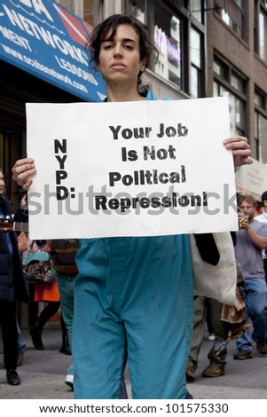 NEW YORK - MAY 1: A protester holds a sign that reads \'NYPD Your Job Is Not Political Repression\' during the march to Union Square at Occupy Wall St \'May Day\' protests on May 1, 2012 in New York, NY.
