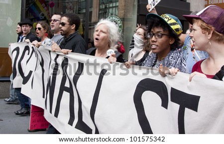 NEW YORK - MAY 1: Protesters holding a sign that reads \'Occupy Wall St\' lead the way during the march to Union Square from Bryant Park at the \'May Day\' protests on May 1, 2012 in New York, NY.