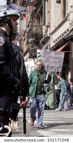 NEW YORK - MAY 1: A protester holds a sign that reads 'No Justice No Peace' during the march to Union Square from Bryant Park at Occupy Wall St 'May Day' protests on May 1, 2012 in New York, NY.