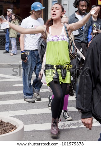 NEW YORK - MAY 1: A protester sings and dances during the march to Union Square from Bryant Park during Occupy Wall St \'May Day\' protests on May 1, 2012 in New York, NY.