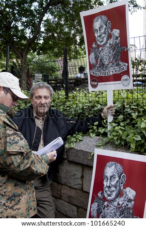 NEW YORK - MAY 1: A protester in Union Square holds a sign depicting Michael Bloomberg as \