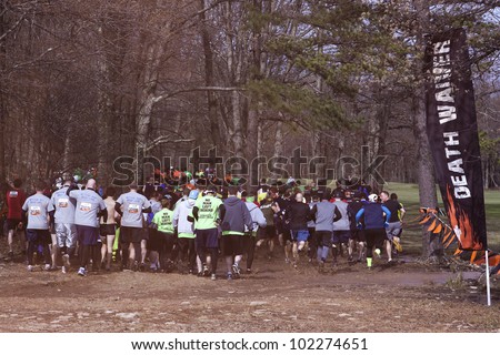 POCONO MANOR, PA - APR 28: Participants begin the event after crossing the start line at Tough Mudder on April 28, 2012 in Pocono Manor, Pennsylvania. The course is designed by British Royal troops.