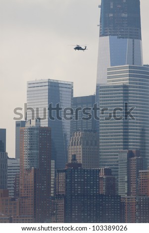 HOBOKEN - MAY 23: A military helicopter flies along the Hudson River over Manhattan during the Parade of Sails on May 23, 2012 in Hoboken, NJ. The parade marks the start of Fleet Week.