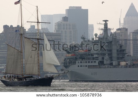 HOBOKEN, NJ - MAY 23: The RFA Argus A135 (UK) passes a tall ship on the Hudson River near Manhattan during the Parade of Sails on May 23, 2012 in Hoboken, NJ. The parade marks the start of Fleet Week.