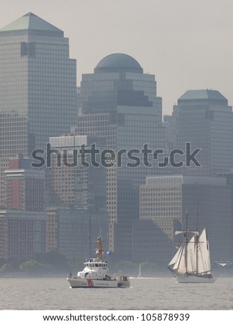 HOBOKEN, NJ -  MAY 23: USCGC Hammerhead and tall ship Etoile (France) sail past the World Financial Center during the Parade of Sail on May 23, 2012 in Hoboken, NJ. The parade is the start of Fleet Week.