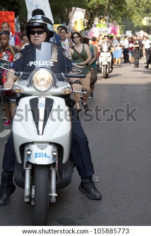 NEW YORK-JUNE 22: Police on motorcycles ride next to hundreds of supporters as they march in Lower Manhattan during the 8th Annual Trans Day of Action on June 22, 2012 in New York City.