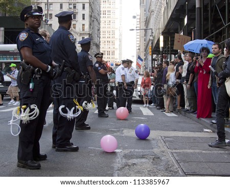 NEW YORK - SEPT 17: Police face protesters assembled on the sidewalk on Broadway near Wall St during the 1yr anniversary of the Occupy Wall St protests on September 17, 2012 in New York City, NY.
