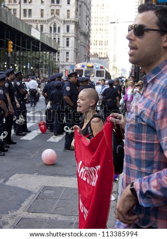 NEW YORK - SEPT 17: Protesters on the sidewalk face a line of policemen on Broadway near Wall St during the 1yr anniversary of the Occupy Wall St protests on September 17, 2012 in New York City, NY.