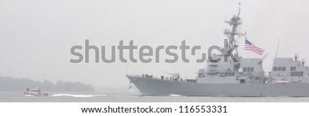 NEW YORK-OCT 9: USS Michael Murphy (DDG 112) departing New York Harbor in rain and fog after being commissioned into service in New York on October 9, 2012. Lt Murphy was a Navy SEAL killed in combat.