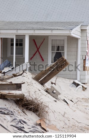 CHADWICK, NJ - JAN 13: A red X spray painted on a home on January 13, 2013 in Chadwick, New Jersey. Clean up continues 75 days after Hurricane Sandy struck the shore in October 2012.