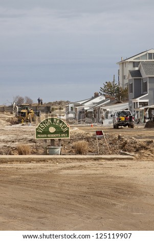 ORTLEY BEACH, NJ - JAN 13: Construction vehicles at work in the Vision Beach community on January 13, 2013 in Ortley Beach, NJ. Clean up continues 75 days after Hurricane Sandy struck in October 2012.