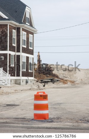 CHADWICK, NJ - JAN 13:An orange construction barrier reads \'Residents Only\' blocking a street on January 13, 2013 in Chadwick, NJ. Clean up continues 75 days after Hurricane Sandy hit in October 2012.