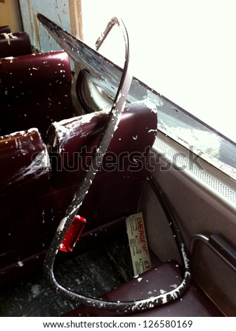 LITTLE FALLS, NJ - JAN 30: A broken window is shown in the first car of a NJ Transit train to NY on January 30, 2013 in Little Falls, NJ. The train collided with a truck carrying paint material.