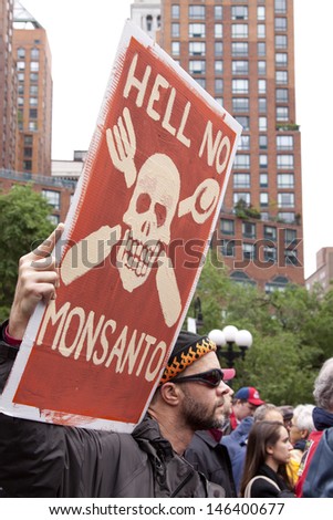 NEW YORK-MAY 25: At March Against Monsanto in Union Square a protestor holds a sign that says \'Hell No Monsanto\' on May 25, 2013 in Manhattan. The rally was part of a global movement against GMO\'s.