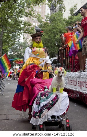 NEW YORK-JUN 30: A participant in brightly color clothes pushes a dog on a stroller during the 44th Annual NYC Pride March on June 30, 2013 in Manhattan.