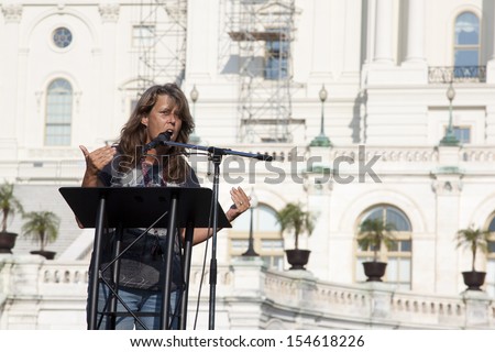 WASHINGTON, DC - SEPT 11: A woman known as \'Mama Bear\' from the 2 Million bikers group speaks at the 911 Justice for Benghazi rally in front of the US Capitol on September 11, 2013 in Washington, DC.