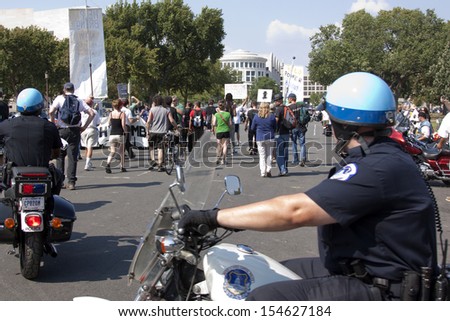 WASHINGTON - SEPT 11: Capitol Police on foot and motorcycles escort a mix of activists, many of whom are 9/11 \