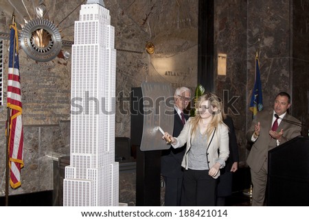 NEW YORK-APR 21, 2014: Actress & Project Sunshine Ambassador Abigail Breslin flips the switch to light the Empire State Building in yellow in honor of Project Sunshine Month.