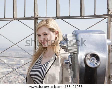 NEW YORK-APR 21, 2014: Actress & Project Sunshine Ambassador Abigail Breslin on the roof of the Empire State Building after flipping the switch to light the building yellow for Project Sunshine Month.