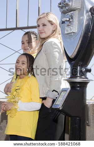 NEW YORK-APR 21, 2014: Actress & Project Sunshine Ambassador Abigail Breslin stands with unidentified children of Project Sunshine on the roof of the Empire State Building for Project Sunshine Month.