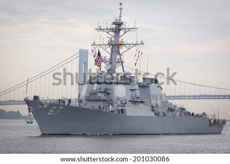 STATEN ISLAND, NY - MAY 21, 2014: Guided-missile destroyer USS Cole (DDG 067) approaching Sullivans Piers with the Verrazano-Narrows Bridge in the background.  The ship is part of Fleet Week NY.